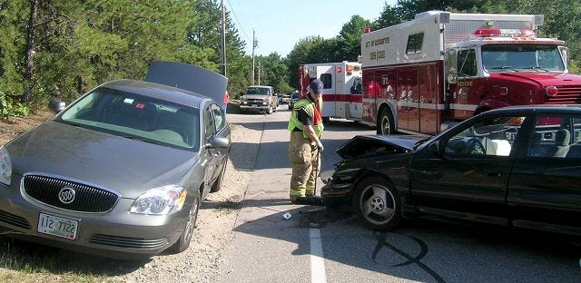 Cresta/Democrat photo 
A Rochester firefighter cleans up hazards following a two-car collision at the intersection of Chestnut Hill Road and Little Falls Bridge Road Friday afternoon.