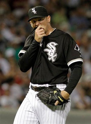 Chicago White Sox relief pitcher J.J. Putz wipes his face during the ninth inning of a baseball game against the Detroit Tigers in Chicago, Saturday, Aug. 14, 2010. The Tigers won 3-2. (AP Photo/Nam Y. Huh)