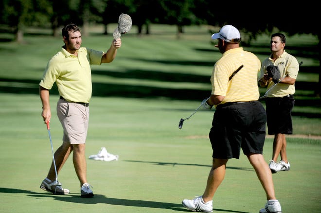 Nick Wilson, left, reacts after winning the Kiwanis Columbia Golf Championship by 11 strokes Sunday at Columbia Country Club.