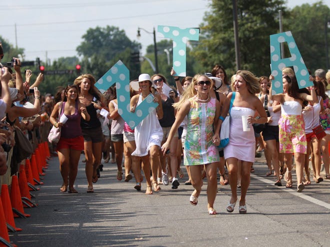 New members of Zeta Tau Alpha walk down Colonial Drive towards their house during Bid Day Sunday, Aug. 15, 2010. Bid Day is the last day of Panhellenic Sorority Recruitment week where the girls find out which sorority they can join.