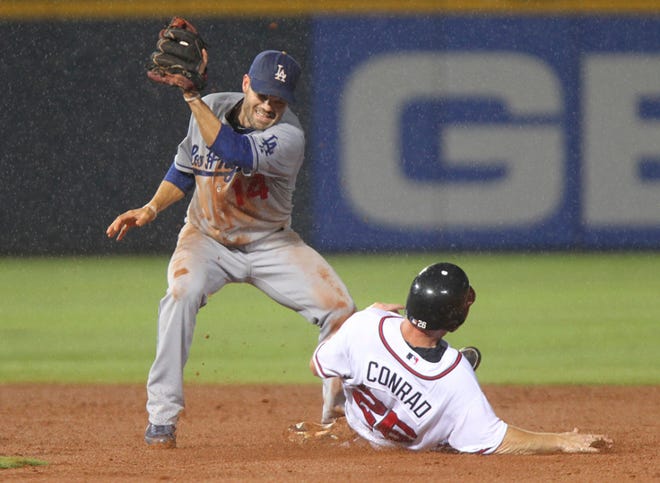 Atlanta Braves. Brooks Conrad (26) steals second base as Los Angeles Dodgers shortstop Jamey Carroll handles the late throw in the fifth inning of a baseball game Monday, Aug. 16, 2010, in Atlanta. (AP Photo/John Bazemore)