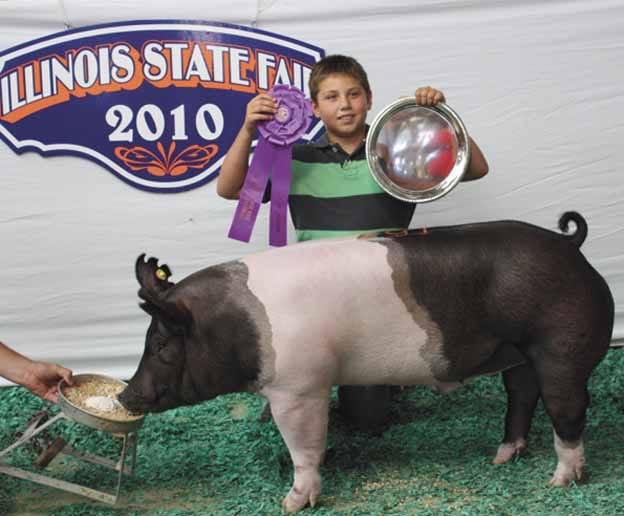 Dylan Decker, 11, of Atkinson, repeated history when he exhibited the grand champion barrow in the Junior Livestock Show at the Illinois State Fair. His father, Greg, showed the grand champion barrow at the State Fair 25 years ago.