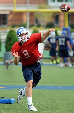 Bentley quarterback Bryant Johnson, of Hopedale, throws a pass during practice yesterday.
