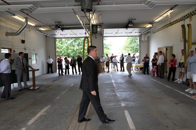 Auctioneer Chris McInnis walks through the former Portsmouth Fire Station 2 as bidding gets underway on Wednesday, Aug. 18, 2010. The property was sold for $550.000.