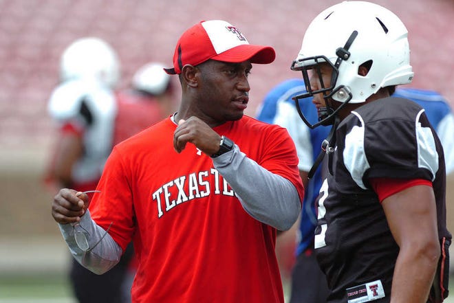 Texas Tech secondary coach Travaris Robinson speaks with Cornelius Douglas during a special teams practice session at Jones AT&T Stadium. (Zach Long)