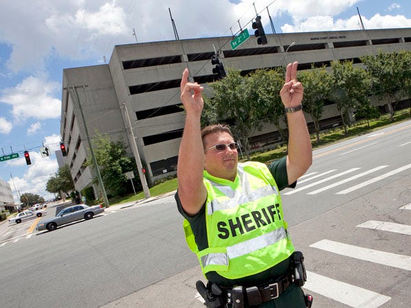Marion County sheriff's Deputy Michael Jablonski redirects traffic away from the Marion County Judicial Center parking garage Thursday following a bomb threat.