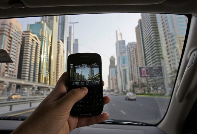 A BlackBerry on Sheikh Zayed highway in Dubai, United Arab Emirates. Dubai 
has given the Canadian company that makes the smart phones until October to 
comply with its laws or face bans on e-mail, messaging and Web services. 
Other countries are threatening bans, too.ASSOCIATED PRESS