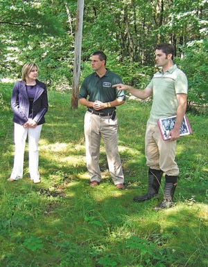 From left, Virginia "Ginger" Murphy, assistant chief for the Natural Resources Conservation Service; Rick Ellsmore, of the federal bureau's Concord office; and Dave Viale, of the Southeast Land Trust, enjoy a moment on the Hauser land in Epping, an ecologically important parcel recently placed under easement with the Emergency Watershed Program for Floodplain Easement of the Natural Resources Conservation Service (NRCS). The land is owned by the Southeast Land Trust and the easement is held by the NRCS.