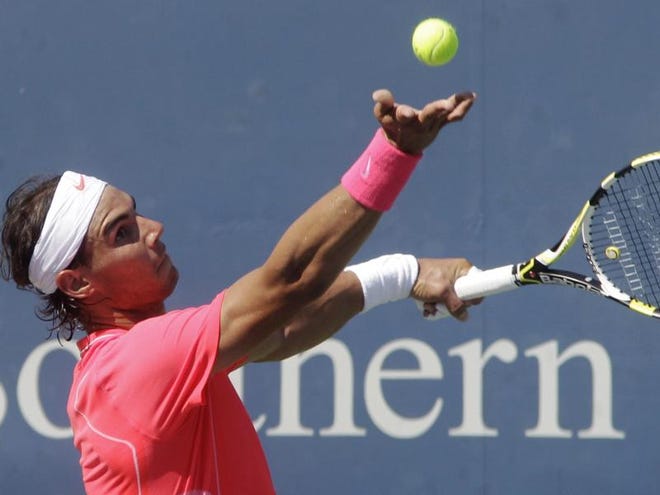 Rafael Nadal, from Spain, serves against Julien Benneteau, from France, during a match at the Cincinnati Masters tennis tournament, Thursday in Mason, Ohio. Nadal won 5-7, 7-6 (6), 6-2.