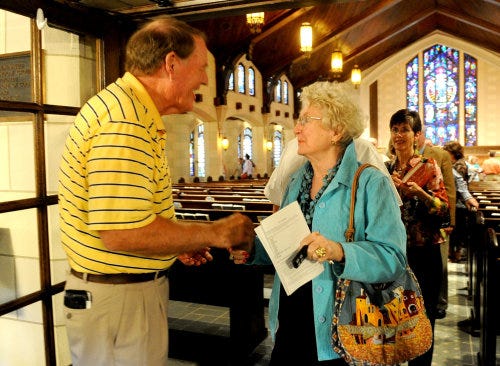 The Rev. Jim Bankhead receives well-wishes from Betty Davenport at the end of his final service at First Presbyterian Church. Bankhead, who was the church?s pastor for 11 years, will serve as the interim associate pastor of discipleship at West Lake Hill