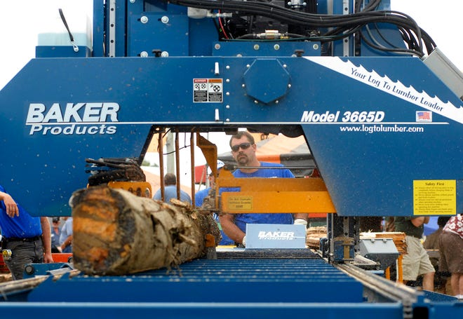 Baker Products employee Bryan Martin demonstrates how to use a portable band sawmill during the 63rd Annual New York State Woodsmen's Field Days at the Boonville-Oneida County Fairgrounds, Saturday, August 21, 2010 in Boonville.