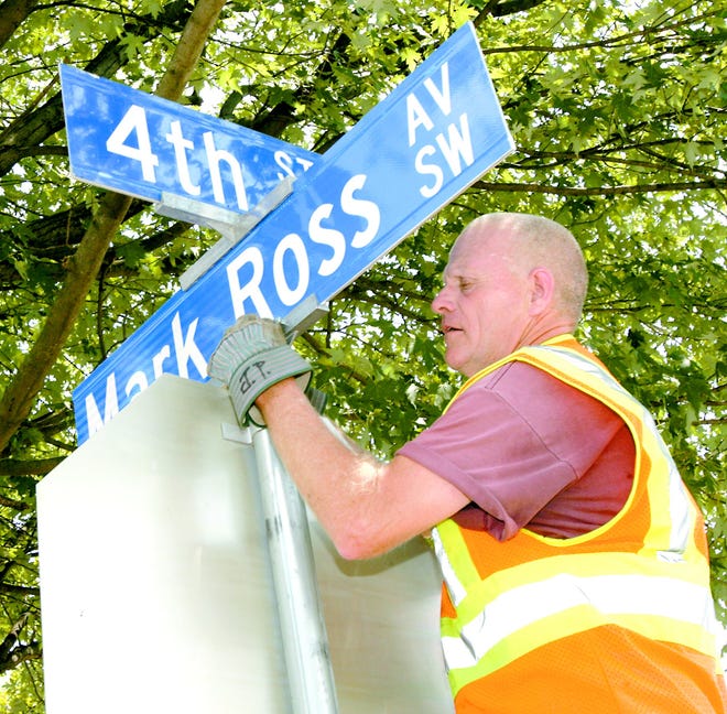 On Friday, Massillon Street Department workers posted new street signs at Duncan, Fourth and Cleveland streets in honor of former Mayor Mark Ross. Here, worker Jim Paulus replaces the Isabella Avenue sign with Mark Ross Avenue SW sign. Ross, a Democrat, served five terms on city council and two as Massillon’s mayor from 1972 to 1980. The Croatian-born Ross moved to Massillon at age 4 with his parents and worked as a barber in the Columbia Heights neighborhood, where he lived for 40 years. He died in 1995.