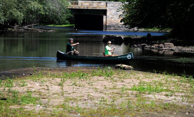 Concord Supt. of Water and Sewer Alan Cathcart and Melissa Simoncini, Environmental and Regulatory Coordinator canoe past Egg Rock where the Assabet and Sudbury Rivers connect to form the Concord River.