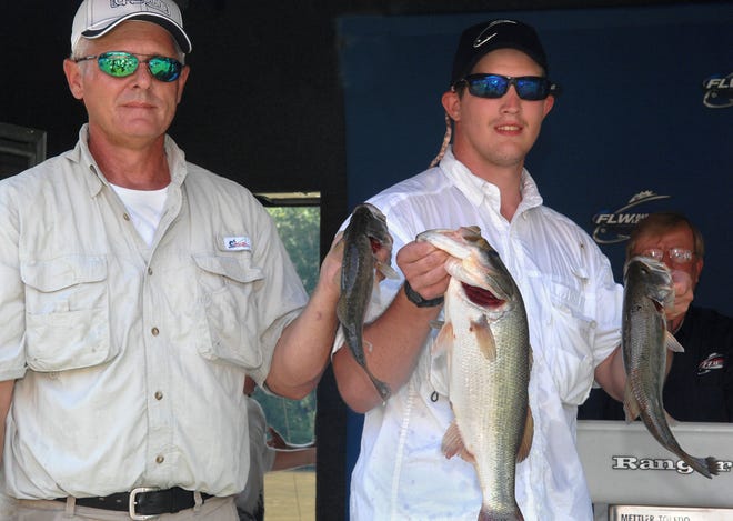 Fisherman Mike Markovcic, at left, and Marine Lance Cpl. Adam Lanier hold some of their catch during, including a large mouth bass that weighed in at more than four pounds, Saturday during the Take A Soldier Fishing, Bass Brawl 2010 tournament. (Photo by Carl Elmore/Savannah Morning News)