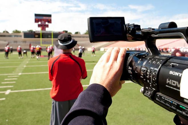 A television camera is trained on Texas Tech football coach Tommy Tuberville during filming of ‘The Ride,’ a reality television show that deals with Tech athletics.