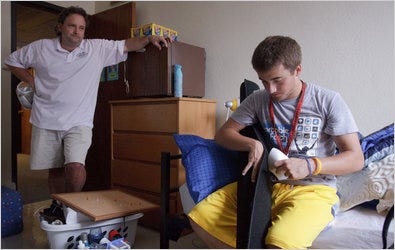 Tim Marsho watches his son Chris move in at Grinnell College.