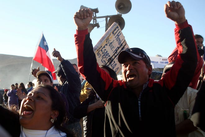 Relatives of workers trapped in a mine react in Copiapo, Chile, after being 
told a drill machine used in the rescue effort had reached the depth where 
the miners were thought to be located. Officials said Sunday that a probe 
came back with a note saying all 33 miners were alive in a 
shelter.ASSOCIATED PRESS / HECTOR RETAMAL