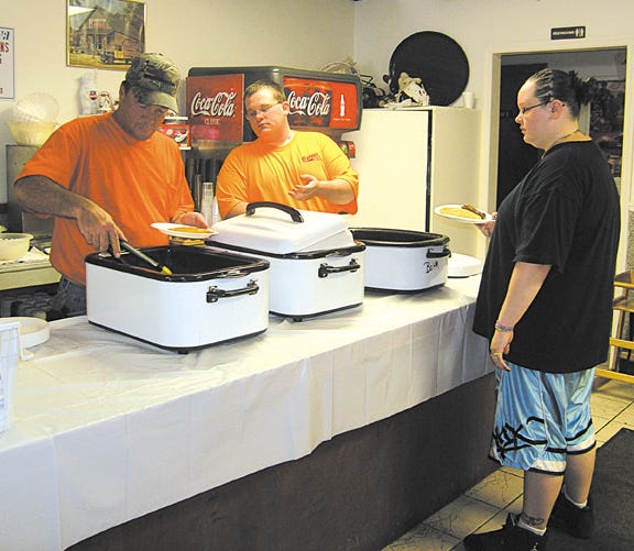 Helping serve pancakes and sausage at the Pit Stop restaurant on Sunday for a fundraiser for the Threshermen’s Reunion Parade were, from left: Larry Blair and Matt LaRose, both of Pontiac; and Brandy Navadomskis, Bloomington.