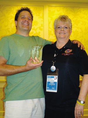 Atlantic Gymnastics owner and head coach Tony Retrosi (left) stands with USA Gymnastics Vice President Kathy Feldman after being named USA Gymnastics’ National Educator of the Year.

Courtesy photo