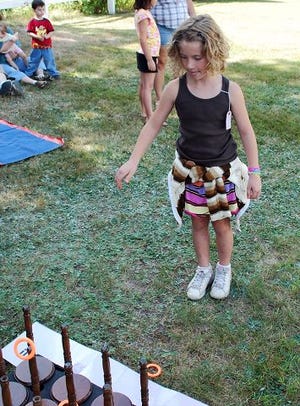photo by CJ Pike
Caitlyn McGibbon, of Buxton, plays the ring toss during Old Home Days in Newfield last weekend.