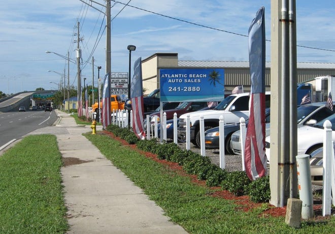 Some businesses, such as Atlantic Beach Auto Sales on Mayport Road, use banners to draw attention. During tough economic times, many business owners want the city to relax sign rules.