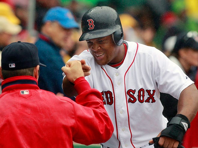 Boston Red Sox's Adrian Beltre, right, is congratulated after scoring on a single by teammate Daniel Nava against the Seattle Mariners during the sixth inning of their baseball game in Boston, Wednesday, Aug. 25, 2010. (AP Photo/Charles Krupa)