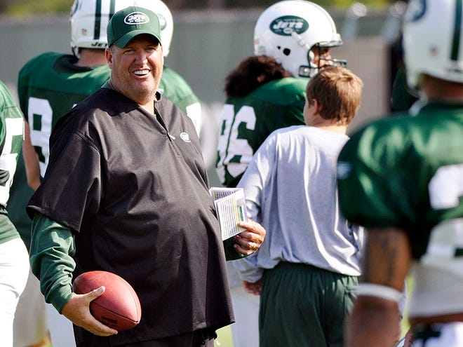 In this Aug. 2, 2010, file photo,, New York Jets head coach Rex Ryan has a laugh with cornerback Dwight Lowery, right, during NFL football training camp in Cortland, N.Y. (AP Photo/Kevin Rivoli, File)