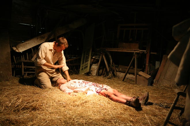 Patrick Fabian, left, and Ashley Bell are shown in a scene from "The Last Exorcism."
