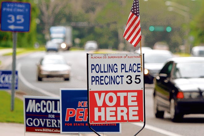 Traffic speeds past a polling place on Williston Road Tuesday morning during primary day for local, state and national elections