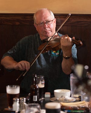 Eamon Coyne, an award-winning fiddle player from Ireland who now lives in Merrimac, plays a traditional Irish folk song with his fellow musicians at Rory O'Connor's Irish Pub.