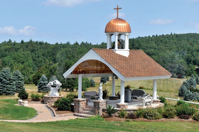 A wedding chapel gazebo structure sits outside the function hall, complete with the bell from the old Holy Family of Nazareth Church.