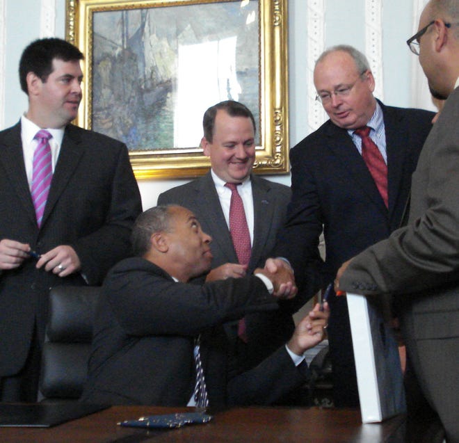 Gov. Deval Patrick shakes hands with state Sen. Steven Tolman at a bill signing last week.