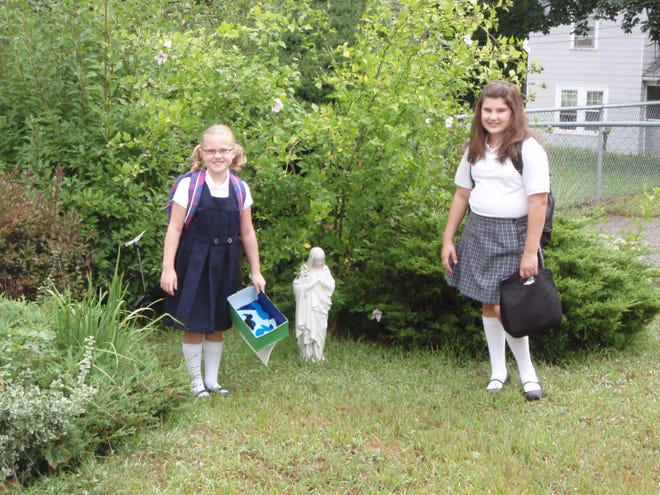 Second-grader Brianne Rett and fifth-grader Grace Rett are ready to go back to school at Our Lady of the Valley Regional School in Uxbridge.