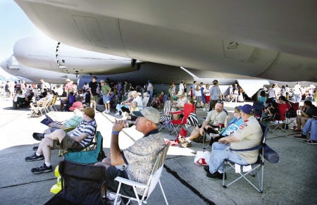 Spectators at the Boston-Portsmouth Air Show on Sunday at the Portsmouth International Airport at Pease seek refuge from the sun under an aircraft.