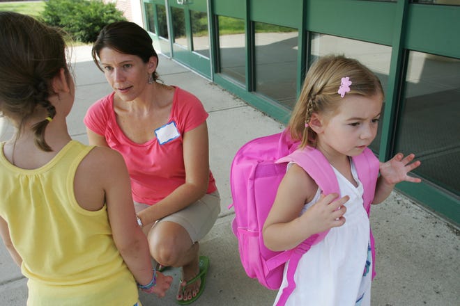 Sydney Paquette, 4, right, of Wrentham, attended Tuesday's pre-school orientation at Wrentham Elementary School with her mom, Kristen, left, and big sister Ella, 5, left, who is going into kindergarden during the first day of school, Aug. 31.