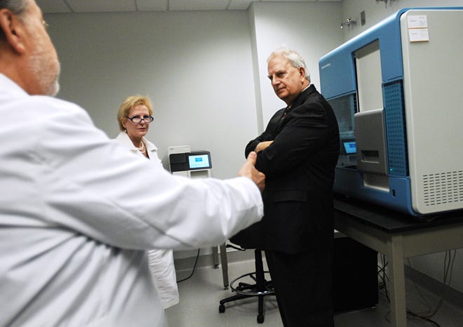 Democratic gubernatorial nominee Roy Barnes talks with Medical College of Georgia's Dr. John Catravas (left) and Dr. Lesleyann Hawthorn during a tour of the MCG Cancer Center.