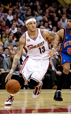 FILE - In this March 1, 2010, file photo, Cleveland Cavaliers guard Delonte West (13) drives past New York Knicks' Eddie House in an NBA basketball game in Cleveland. Free agent guard Delonte West was suspended without pay for 10 games Friday after pleading guilty last month to weapons charges. (AP Photo/Tony Dejak, File)