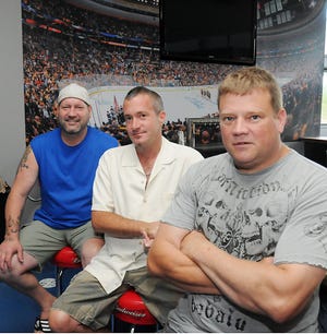 Former Boston Bruins player Lyndon "LB" Byers, left, with partners Timothy Hanna, center, and Richard Oleson, are planning to open a restaurant, Angry Ham's Garage, on Beacon Street in Framingham.