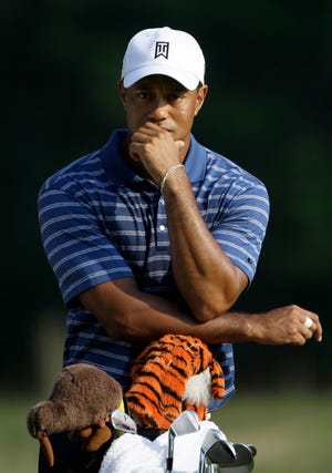 Tiger Woods leans against his bag before putting on the fourth hole of a pro-am round during the Deutsche Bank Championship at TPC Boston in Norton on Thursday.