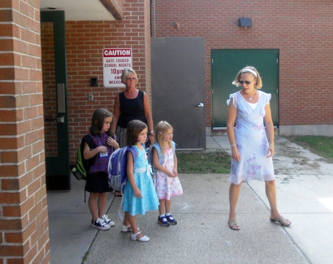 Some of Ashford School's youngest students wait in line to board the school
bus at the end of the day Wednesday. Students in Ashford returned to school
Wednesday.