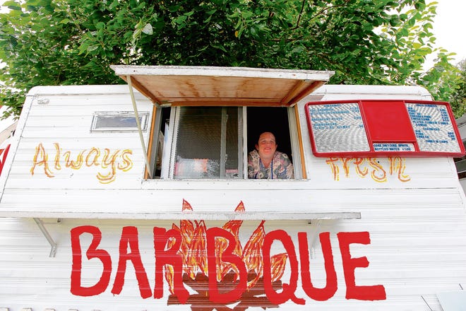 Debbie Price poses in front of her business, Price Family Barbecue. The barbecue stand is located at 1916 NE Waldo Road.