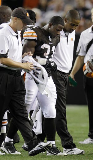 Cleveland Browns running back Montario Hardesty is helped off the field after an injury in the second quarter of a preseason NFL football game against the Chicago Bear.