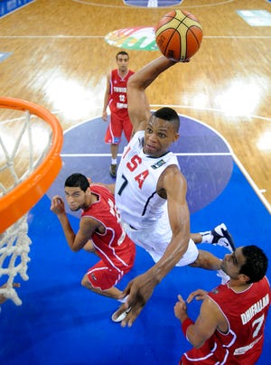 Russel Westbrook goes up for a dunk as Tunisia's Salah Mejri, left, and Mohamed Naim Dhifallah look on during the United States' victory on Thursday at the World Basketball Championships in Istanbul, Turkey.
