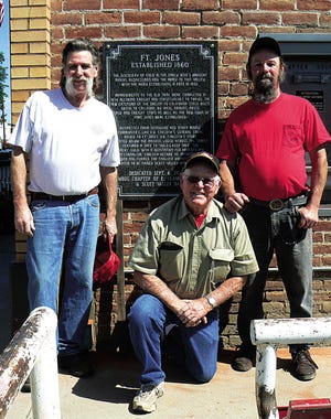 One of the many events set for the 150th anniversary of the naming of Fort Jones is the 12:30 p.m. (time approximate) Saturday dedication of a historical plaque co-sponsored by the Humbug Chapter of E. Clampus Vitus 73 and Scott Valley Bank and located on the west side of the bank’s Fort Jones branch on Main Street. Dedication takes place directly following the noon Sesquicentennial Parade. Above, from left, are Humbug Chapter Historian Dan Reimers; Glenn Hearell, an Oregon Clamper; and Humbug President James “Dirt” Ordway, pictured on Tuesday after Reimers and Ordway helped Hearell install the plaque.