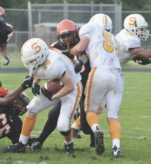 Sturgis’ Chris Alexander avoids being tackled by a Benton Harbor defender on Thursday night.