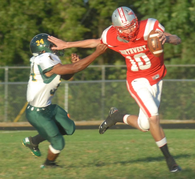 Northwest's Nick Riley pushes off from Firestone's Steve Boardnax on Friday night.