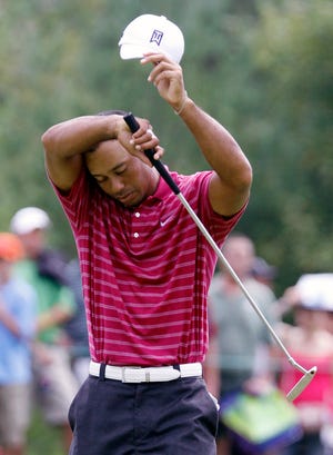 Tiger Woods wipes his head at the 10th hole during the first round of the Deutsche Bank Championship on Friday.
