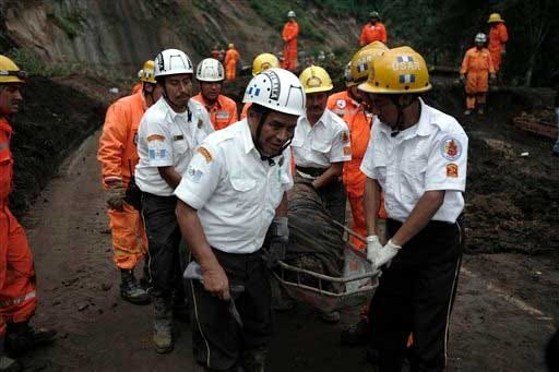 Rescue workers carry the body of a mudslide victim in Nahuala, western Guatemala, Sunday, Sept. 5, 2010. At least 38 people were killed after torrential rains caused mudslides in different areas of the country, injuring 20 others and leaving over 60 people missing.