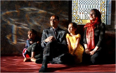 Dr. Ferhan Asghar at a Muslim center in West Chester, Ohio, with his wife, Pakeeza, and daughters Zara, left, and Emaan.