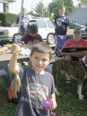 Here Ethan Erhart of New Windsor brings in his 5 3/4-inch blue gill for measuring, not big enough or small enough for a prize, but fun to catch anyways. Catch the fourth annual Viola Threshers Reunion Sept. 11 - 12. Saturday at 10 a.m. is when the kid's fishing takes place.
